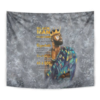 Close wall view of gray tapestry with crowned portrait figure and yellow text over it