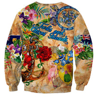 Orange unisex sweatshirt, rear view with anchor, tropical flowers, and Turks & Caicos Islands print