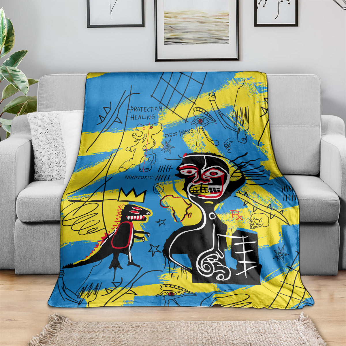 Blue and yellow psychedelic skull-face art blanket spread across a gray sofa