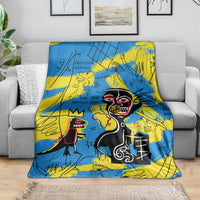 Blue and yellow psychedelic skull-face art blanket spread across a gray sofa