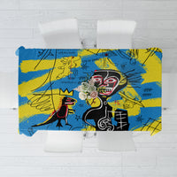 Psychedelic blue and yellow tablecloth with bold face and graffiti-style symbols