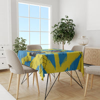 Blue and yellow psychedelic tablecloth covering a dining table with four chairs
