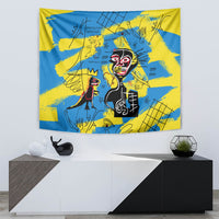 Square wall tapestry in blue and yellow with red-face characters and graphic line details