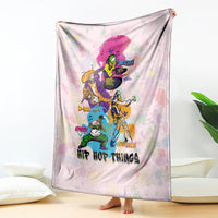 Light pink hip hop blanket draped upright with colorful character collage and text