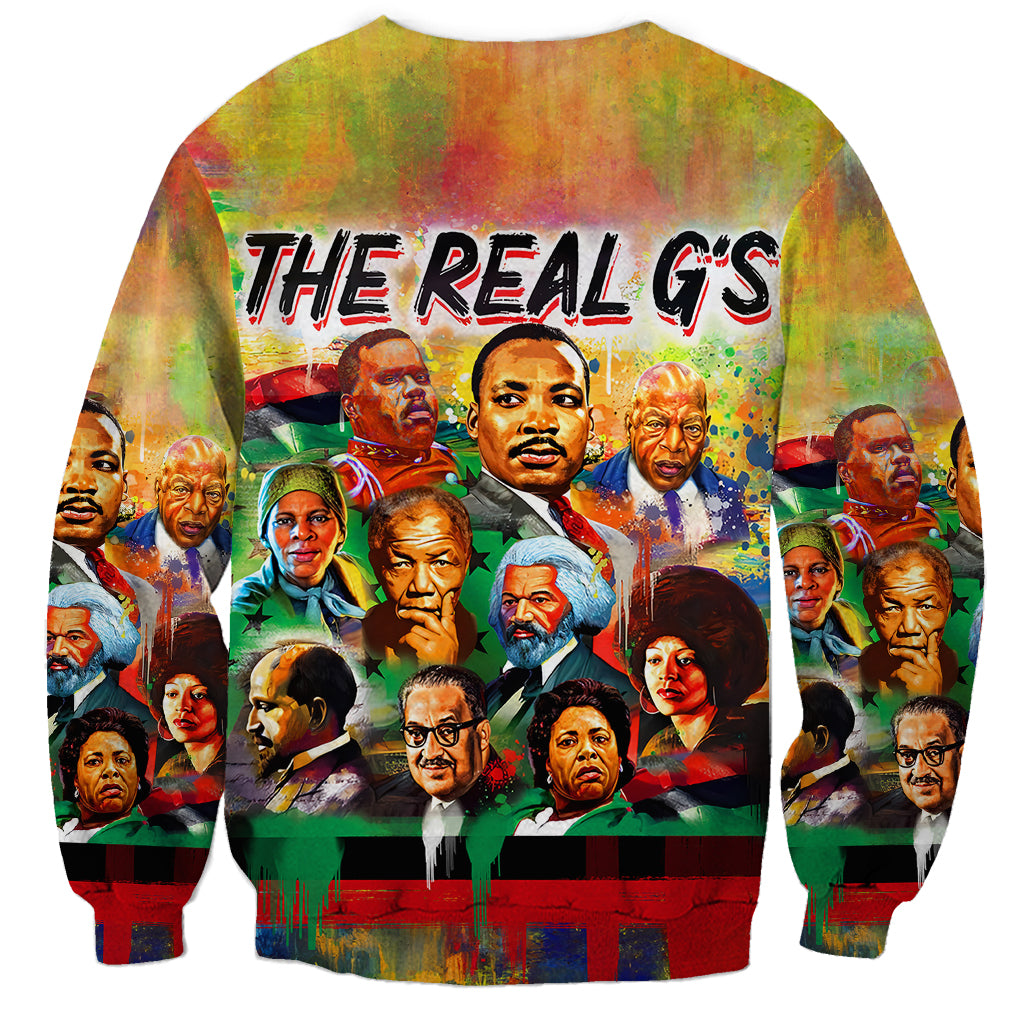 Unisex sweatshirt with ribbed hem, centered “THE REAL G’S” graphic and colorful portrait collage