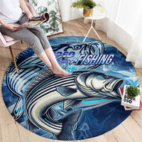 Blue round fishing carpet with striped bass graphic, wave design, and fishing wordmark