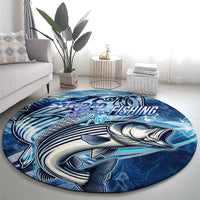 Blue round fishing rug featuring striped bass fish artwork and ocean wave pattern
