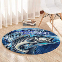 Blue round fishing rug with striped bass artwork and textured ocean wave pattern