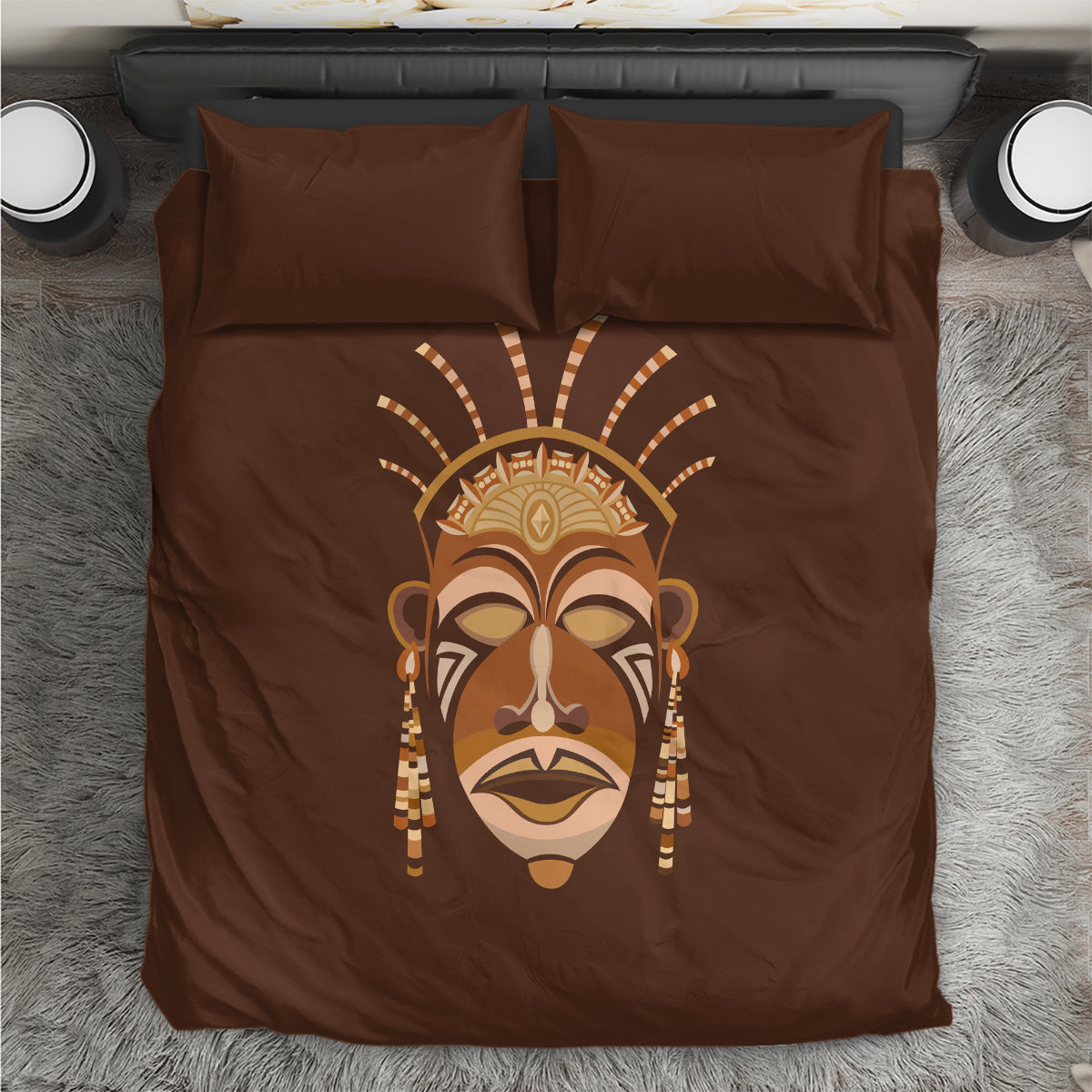 Brown bedding set with central tribal mask graphic and matching pillowcases
