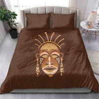 Brown duvet cover and two pillows featuring a tribal mask face print