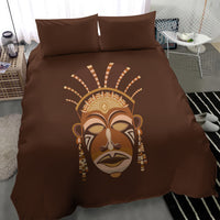 Brown duvet cover with large tribal mask print and two matching pillow shams