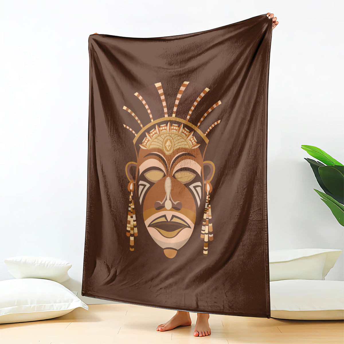 Brown tribal face print blanket, large square draped open on the floor
