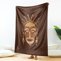 Brown tribal face print blanket, large square draped open on the floor