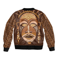 Bomber jacket with large tribal mask print, brown/gold tones, ribbed cuffs and waistband