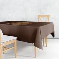Brown tribal tablecloth covering table with matching overhang and printed mask panel