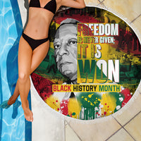 Round beach blanket with fringe edge beside pool, Black History Month portrait and text
