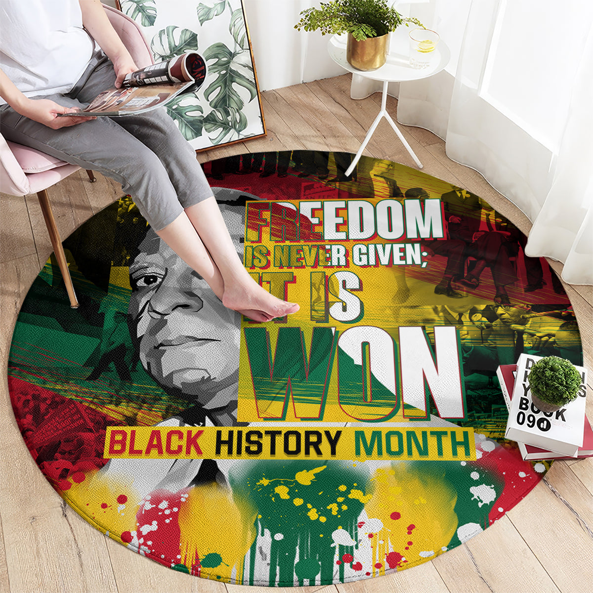 Round carpet with large “IT IS WON” lettering and Black History Month graphic design.