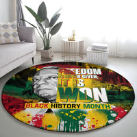 Round carpet featuring “Freedom Is Never Given…” and “Black History Month” in colorful print.