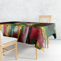 Colorful art-print tablecloth draped over a table with graphic stripes and splatter