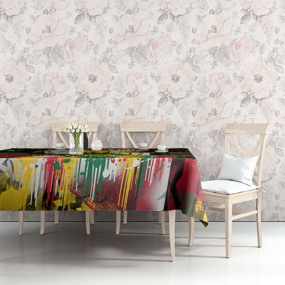 Art-print tablecloth with vibrant vertical paint streaks and collage graphics on a table