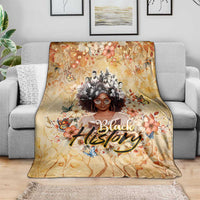Beige floral blanket with central woman portrait, butterflies, and 'Black' script