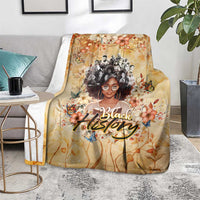 Beige floral throw blanket on floor with woman portrait and decorative 'Black' text