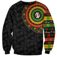Black unisex sweatshirt with repeating adinkra symbols and large colorful circular print
