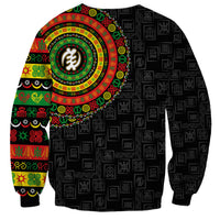 Black unisex sweatshirt with dense adinkra pattern and colorful round emblem center