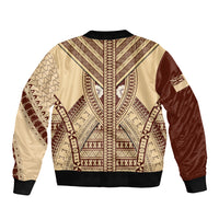 Beige bomber jacket with brown tapa pattern, black ribbed collar and cuffs
