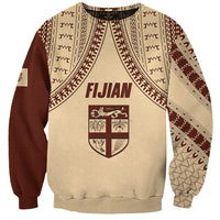 Beige unisex sweatshirt with maroon tapa-pattern panels and Fijian shield graphic