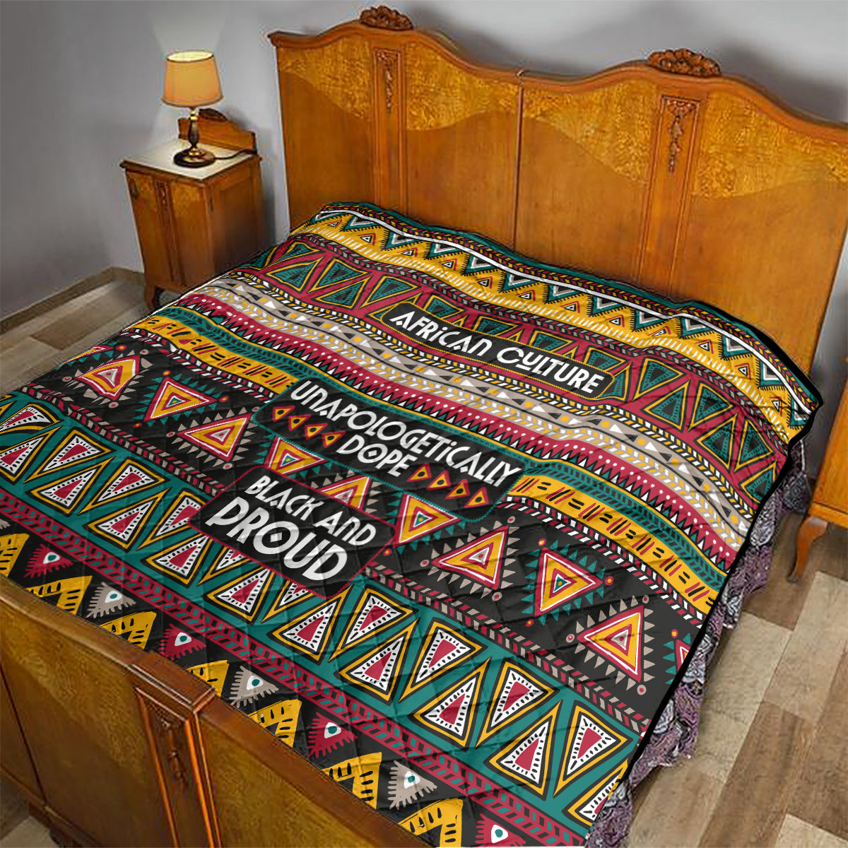 Colorful African-pattern quilt spread over a bed, showing “African Culture” and “Black and Proud” text.