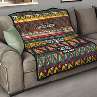Colorful African-pattern quilt on a sofa seat, with geometric pattern and text “African Culture” and “Black and Proud.”