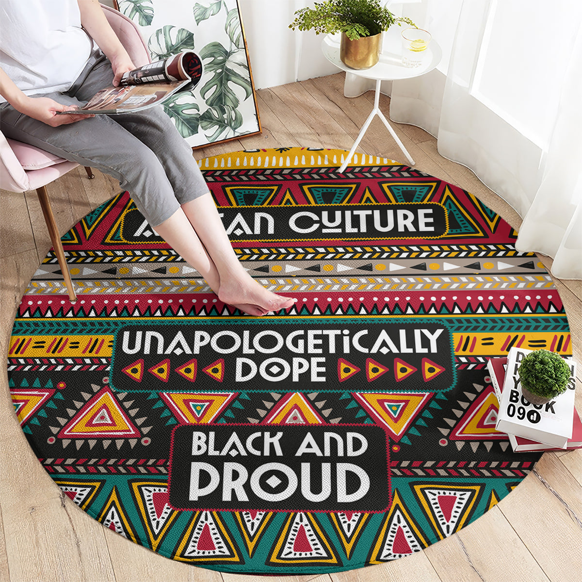 Round carpet with African tribal geometric pattern in black, red, yellow, and green; bold centered text.