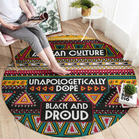 Round carpet with African tribal geometric pattern in black, red, yellow, and green; bold centered text.