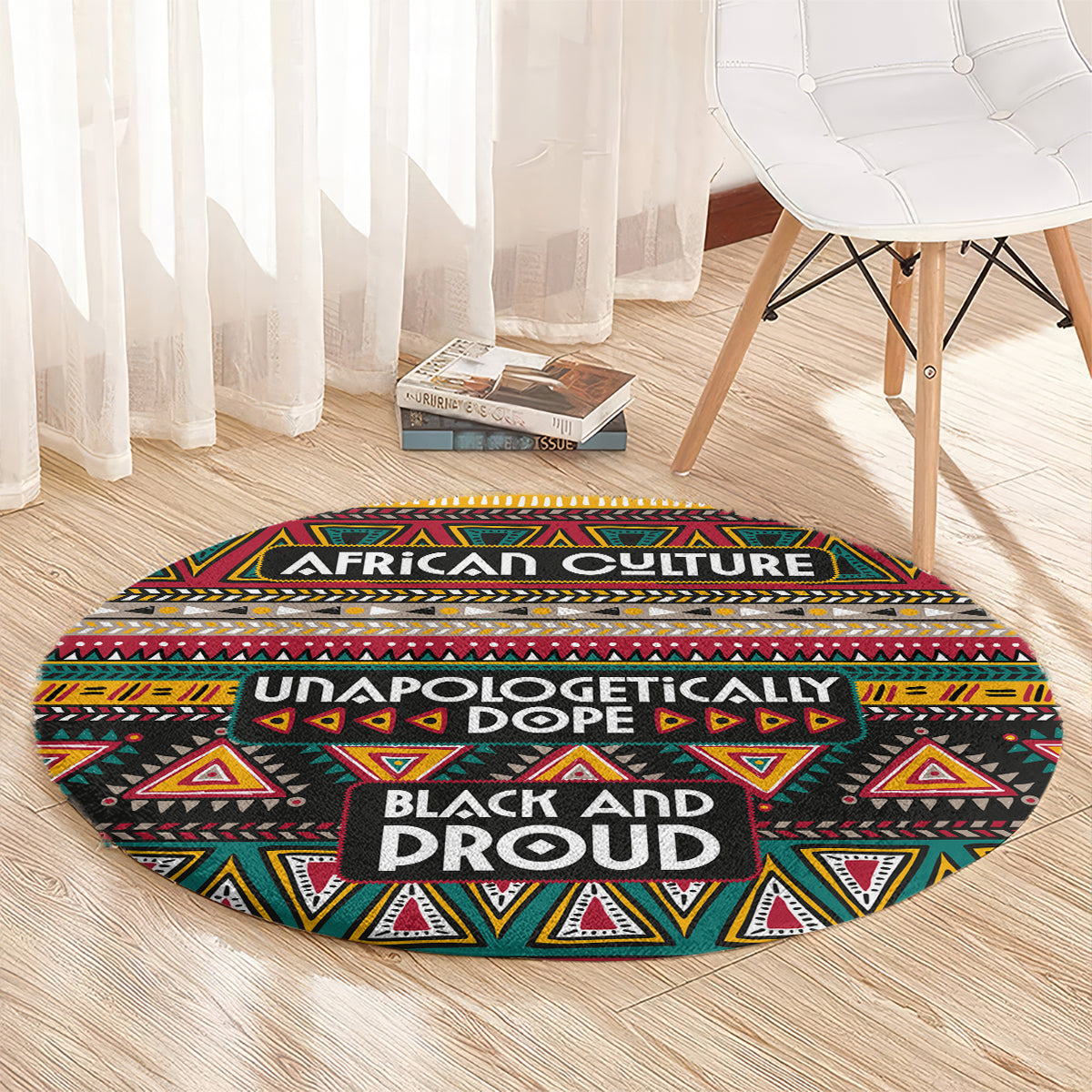 Round African-pattern carpet with black background, red yellow green triangles, and “BLACK AND PROUD” lettering.