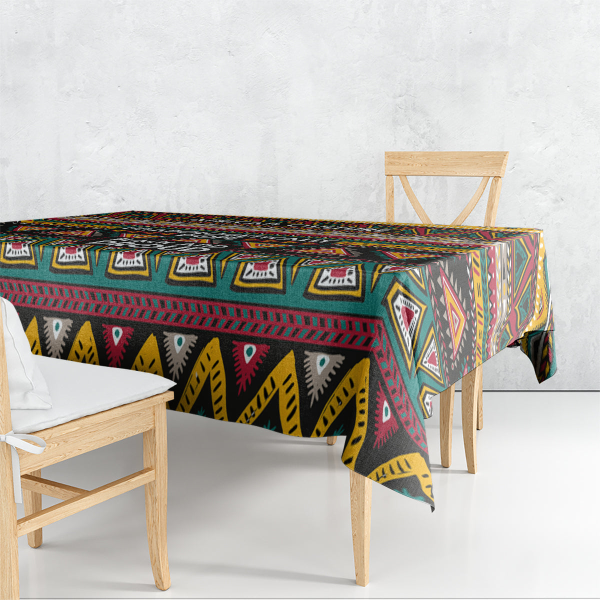 Square geometric African patterned tablecloth draped to the floor, black, teal, maroon and yellow
