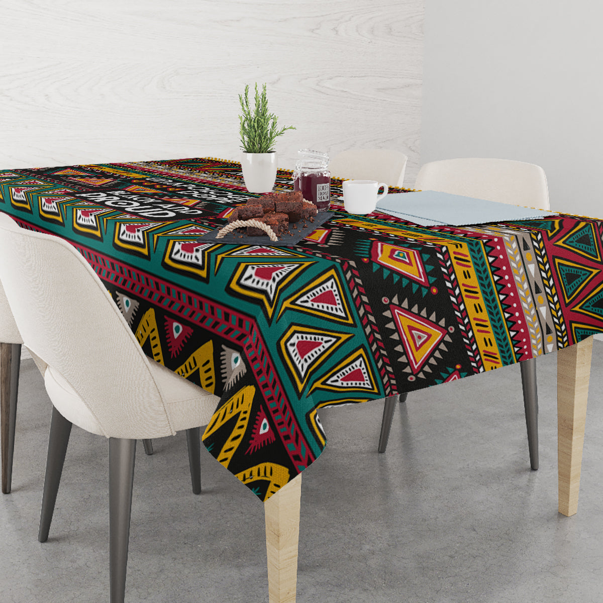 Geometric African patterned tablecloth with bold triangles and stripes in black, teal, maroon, yellow