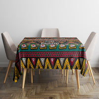 Geometric African patterned tablecloth in black, teal, maroon and yellow over a square table