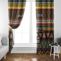 African pattern window curtains framing a white door with colorful triangle and stripe design