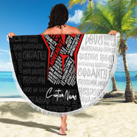 Person holding a round fringed beach blanket; black word pattern with red civil rights fist design