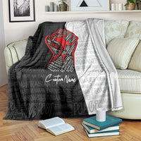Black and gray blanket with red justice fist graphic, repeating text pattern, custom name