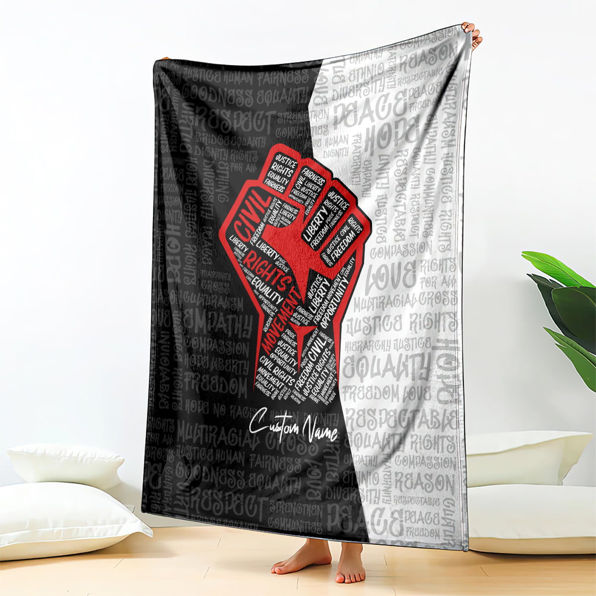 Black and gray blanket with red justice fist logo and repeating word pattern, custom name