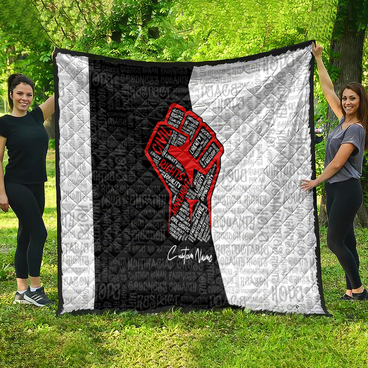 Personalized civil rights movement quilt held outdoors, black-and-white panels with red fist graphic