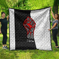 Personalized civil rights movement quilt held outdoors, black-and-white panels with red fist graphic