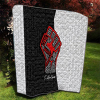 Personalized civil rights movement quilt in outdoor view, black-and-white quilt with red fist emblem