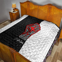Personalized civil rights movement quilt on bed, black-and-white with central red fist design