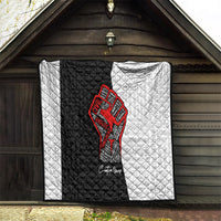 Personalized civil rights movement quilt hanging indoors, black-and-white with red fist emblem