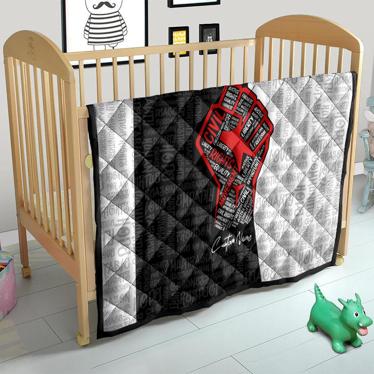 Personalized civil rights movement quilt laid flat over a crib, black-and-white with red fist