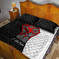 Quilt bed set with black quilt, red raised-fist graphic, and white patterned panel