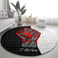 Round justice-themed carpet with red raised-fist graphic, black/gray text pattern, custom name